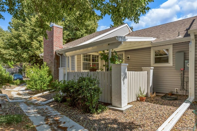 13701 E Marina Dr Unit B, Aurora, CO 80014 - property entrance with a chimney and roof with shingles