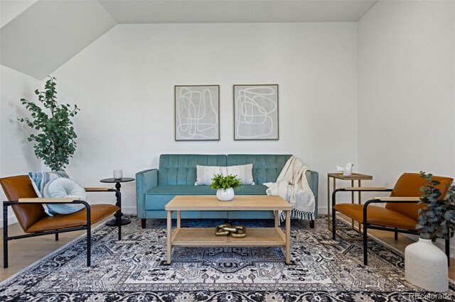 1601 Park Ave Unit 216, Denver, CO 80218 - living area featuring lofted ceiling, baseboards, and wood finished floors