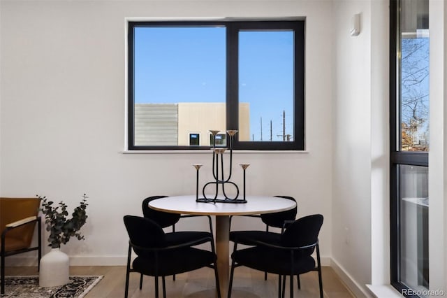 1601 Park Ave Unit 216, Denver, CO 80218 - dining room featuring baseboards and wood finished floors