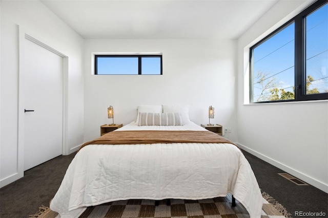 1601 Park Ave Unit 216, Denver, CO 80218 - bedroom with dark colored carpet and baseboards