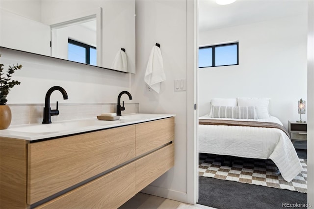 1601 Park Ave Unit 216, Denver, CO 80218 - bathroom featuring double vanity, ensuite bathroom, and backsplash