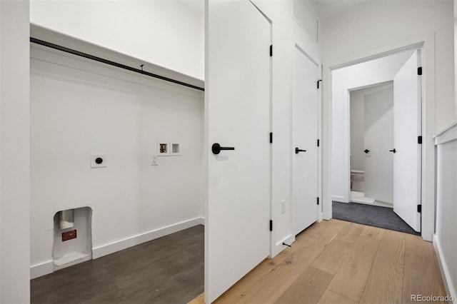 laundry room with hookup for a washing machine, light hardwood / wood-style flooring, and electric dryer hookup