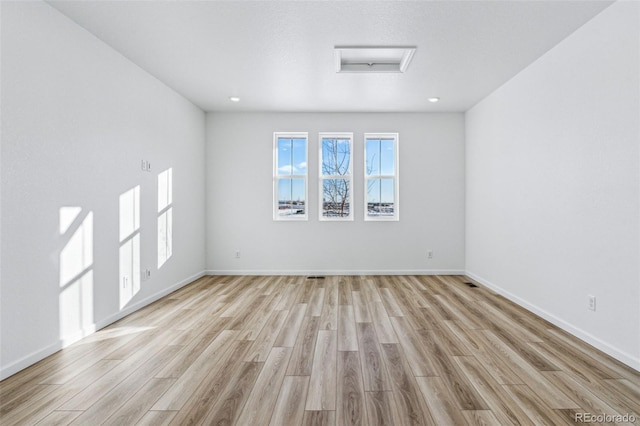 unfurnished room featuring light wood-type flooring and baseboards