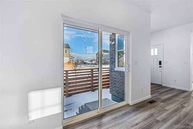 entryway featuring baseboards and wood finished floors