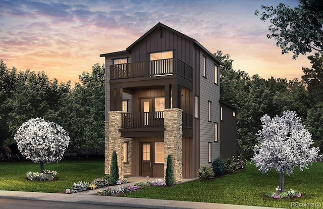 8631 Hotchkiss St, Littleton, CO 80125 - view of front facade featuring a balcony, board and batten siding, stone siding, and a lawn