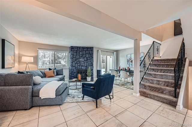 living room featuring light tile patterned floors and a fireplace