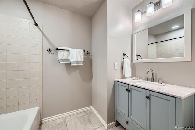 bathroom with tile patterned floors, vanity, and tiled shower / bath