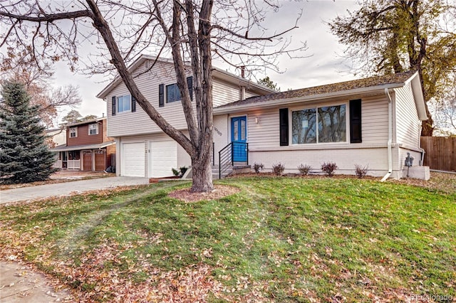 tri-level home with a front yard and a garage