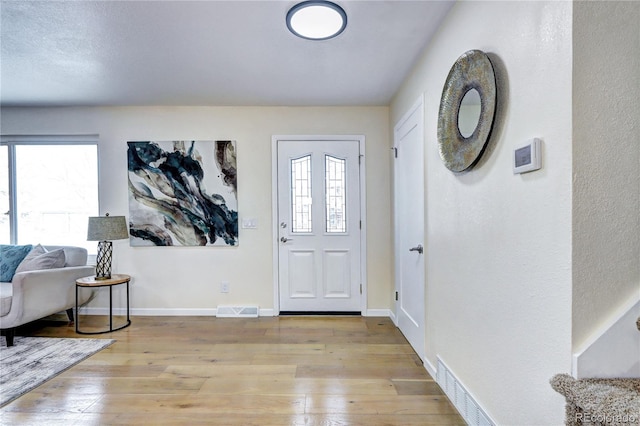 foyer entrance with light wood-type flooring