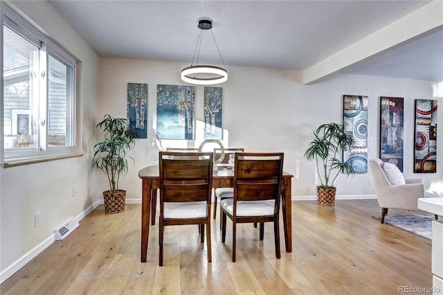 dining space with light hardwood / wood-style floors