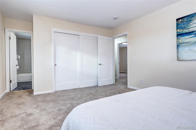 bedroom with carpet flooring, connected bathroom, and a closet