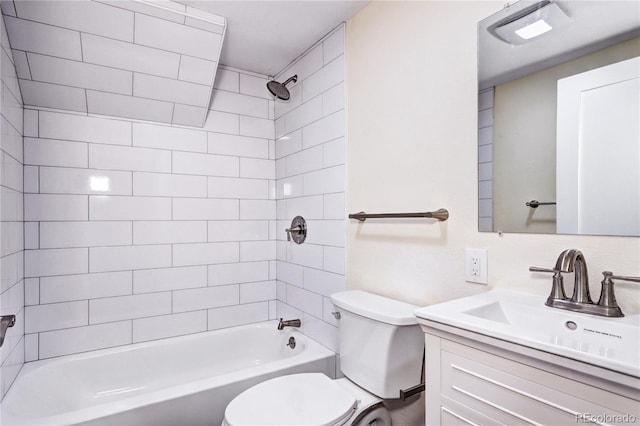 full bathroom with vanity, tiled shower / bath, and toilet