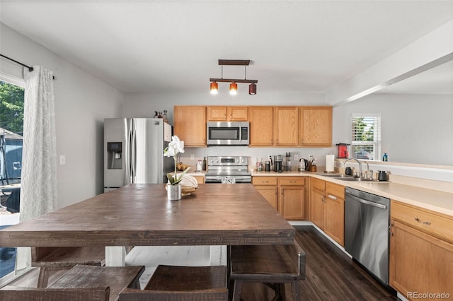 4695 Andes St, Denver, CO 80249 - kitchen featuring appliances with stainless steel finishes, dark wood-style flooring, light countertops, pendant lighting, and light brown cabinets
