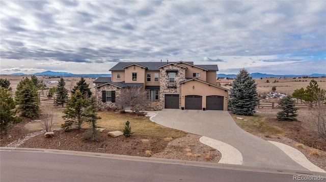 view of front of home with a mountain view and a garage