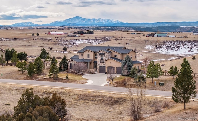 drone / aerial view featuring a mountain view and a rural view