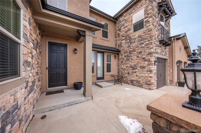 view of exterior entry with a garage