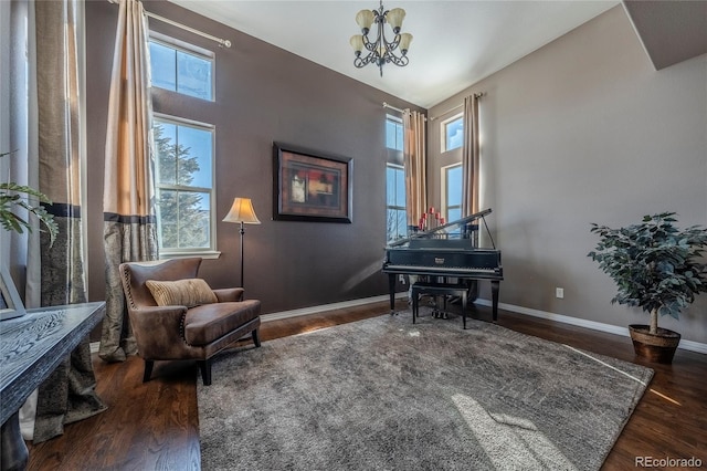 living area with a chandelier, a wealth of natural light, and dark wood-type flooring