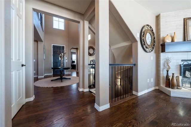 foyer with a high ceiling and dark hardwood / wood-style floors