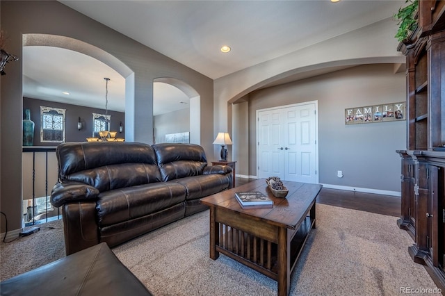 living room with carpet and a notable chandelier