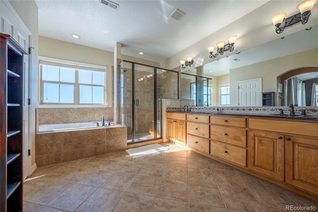 bathroom with plus walk in shower, tile patterned flooring, and vanity