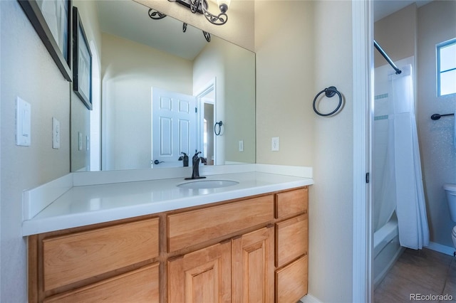 full bathroom featuring tile patterned flooring, vanity, toilet, and shower / tub combo with curtain