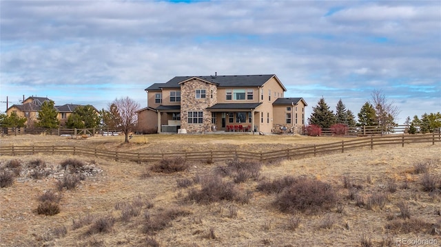 view of front facade featuring a rural view