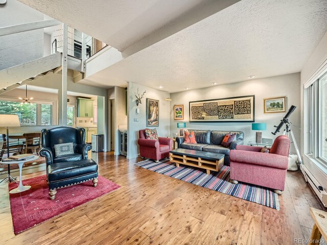 1370 Sandstone Dr Unit 12, Vail, CO 81657 - living area featuring hardwood / wood-style flooring, a textured ceiling, baseboard heating, and recessed lighting