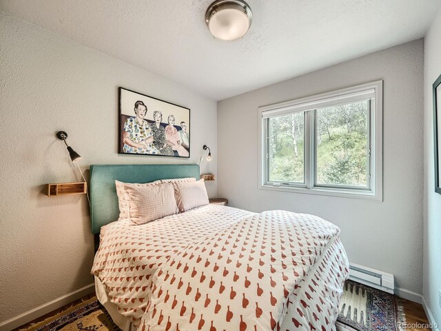 1370 Sandstone Dr Unit 12, Vail, CO 81657 - bedroom with baseboard heating and wood finished floors