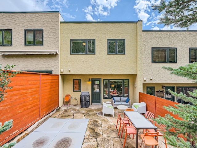 1370 Sandstone Dr Unit 12, Vail, CO 81657 - rear view of house featuring stucco siding, a patio area, a fenced backyard, and an outdoor hangout area