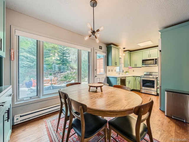 1370 Sandstone Dr Unit 12, Vail, CO 81657 - dining area featuring a baseboard heating unit, a textured ceiling, and light wood finished floors