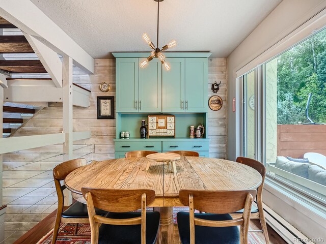 1370 Sandstone Dr Unit 12, Vail, CO 81657 - dining room with stairway, a baseboard radiator, wooden walls, and a textured ceiling