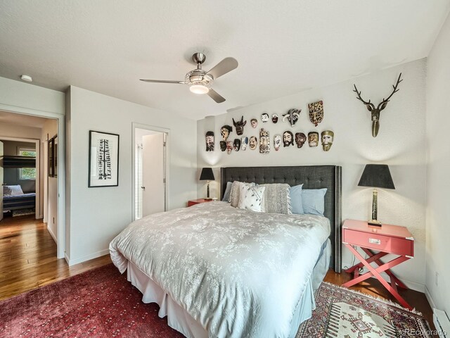 1370 Sandstone Dr Unit 12, Vail, CO 81657 - bedroom featuring wood finished floors, ceiling fan, and a baseboard heating unit