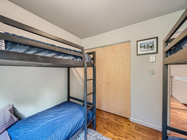 1370 Sandstone Dr Unit 12, Vail, CO 81657 - bedroom with wood finished floors and a textured ceiling