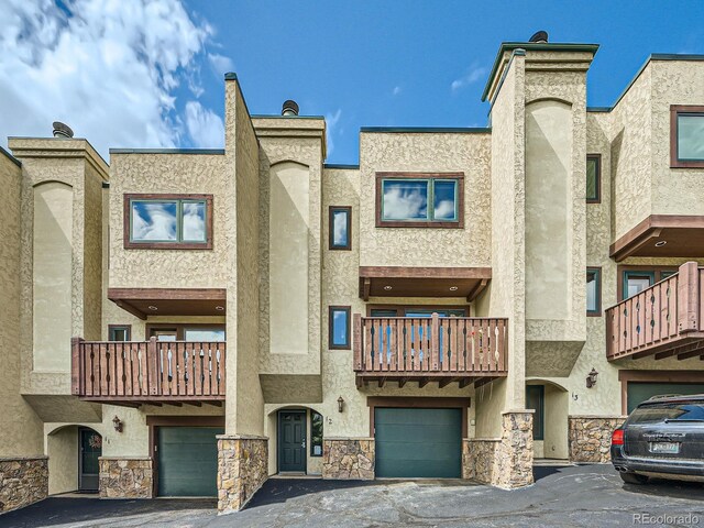 1370 Sandstone Dr Unit 12, Vail, CO 81657 - view of front of home with an attached garage and stucco siding