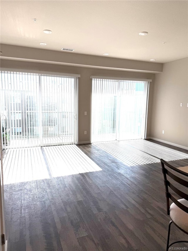 unfurnished living room with dark hardwood / wood-style flooring