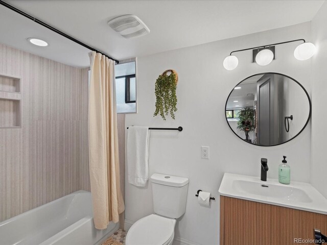 full bathroom featuring vanity, shower / bath combo, and toilet