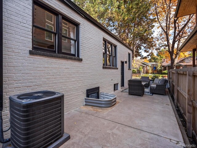 view of property exterior featuring cooling unit, an outdoor living space, and a patio area