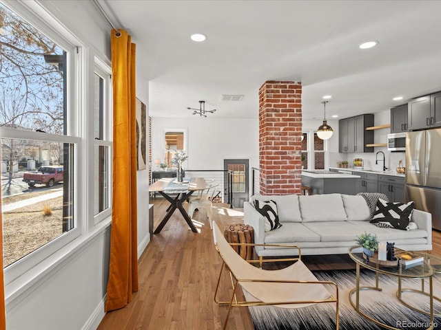 living room featuring sink and light wood-type flooring