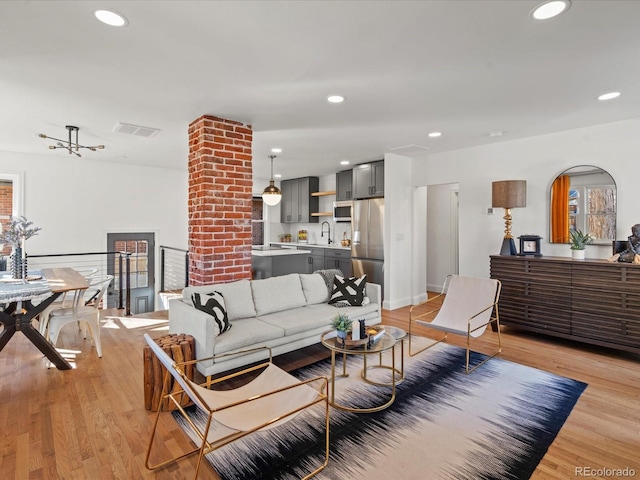 living room with sink and light hardwood / wood-style floors