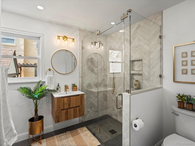 bathroom with vanity, toilet, and an enclosed shower