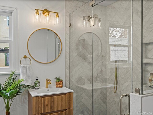 bathroom with vanity and a shower with shower door