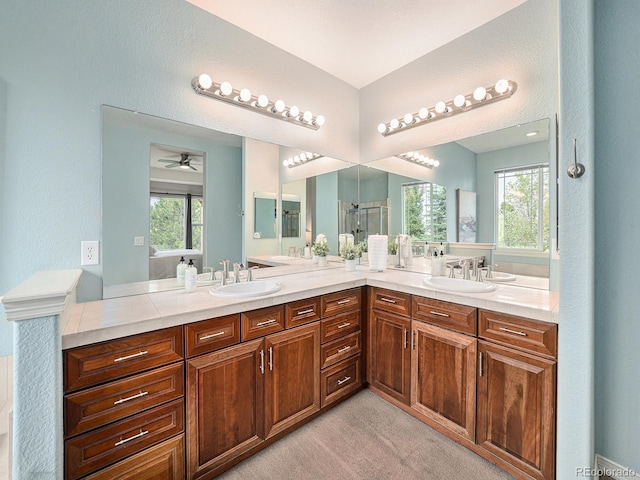 19379 W 57th Pl, Golden, CO 80403 - full bathroom featuring a sink, ceiling fan, a shower stall, and double vanity