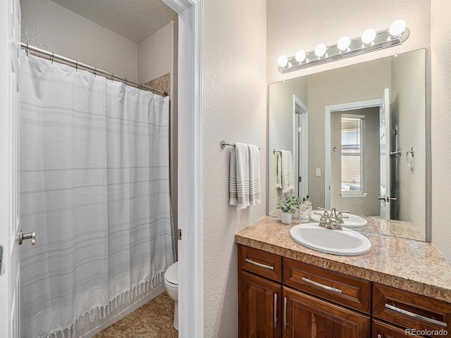 19379 W 57th Pl, Golden, CO 80403 - bathroom with toilet, a textured wall, tile patterned floors, and vanity