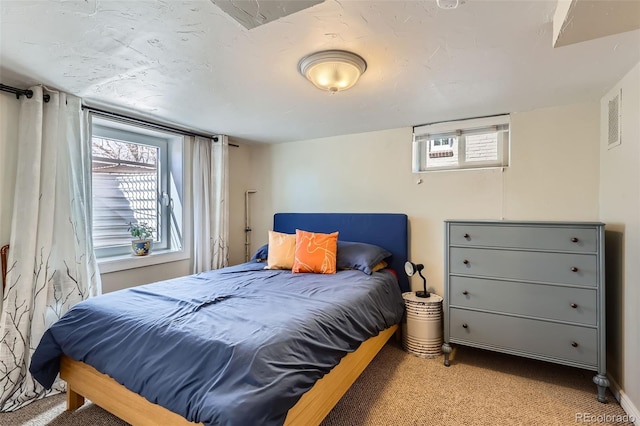 carpeted bedroom with visible vents and multiple windows