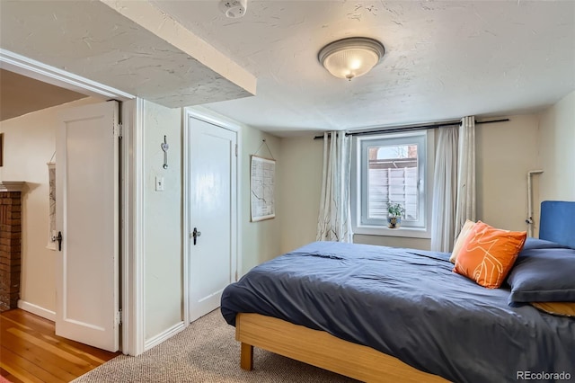 bedroom with baseboards and light wood finished floors