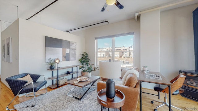 living area featuring ceiling fan and hardwood / wood-style flooring