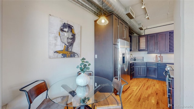 kitchen with stainless steel fridge with ice dispenser and light wood-type flooring