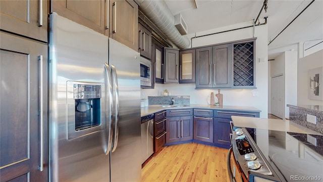 kitchen featuring stainless steel appliances, light hardwood / wood-style flooring, and sink