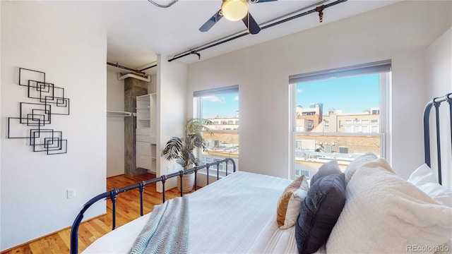 bedroom with ceiling fan and hardwood / wood-style flooring