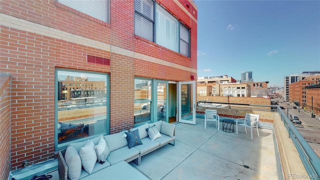 view of patio featuring a balcony and an outdoor hangout area